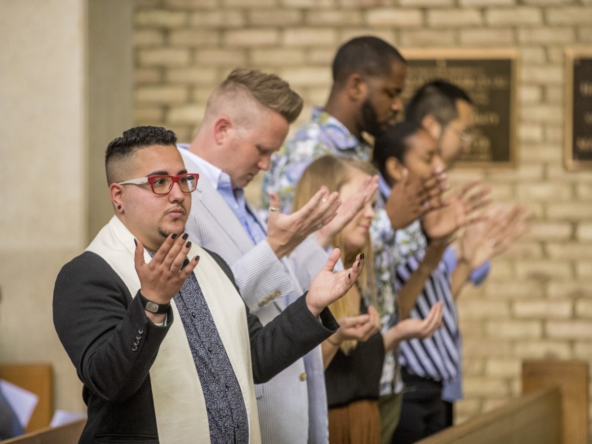 congregation members with raised hands