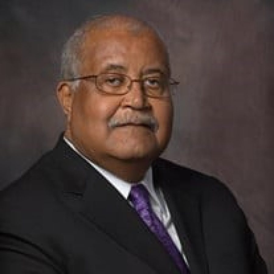 William DeVeaux wearing a black suit and purple tie