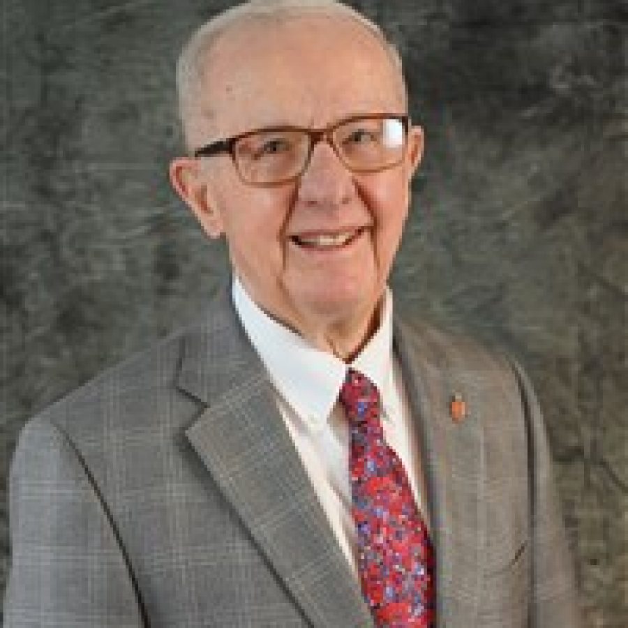 Joe Pennel in a gray suit and red tie