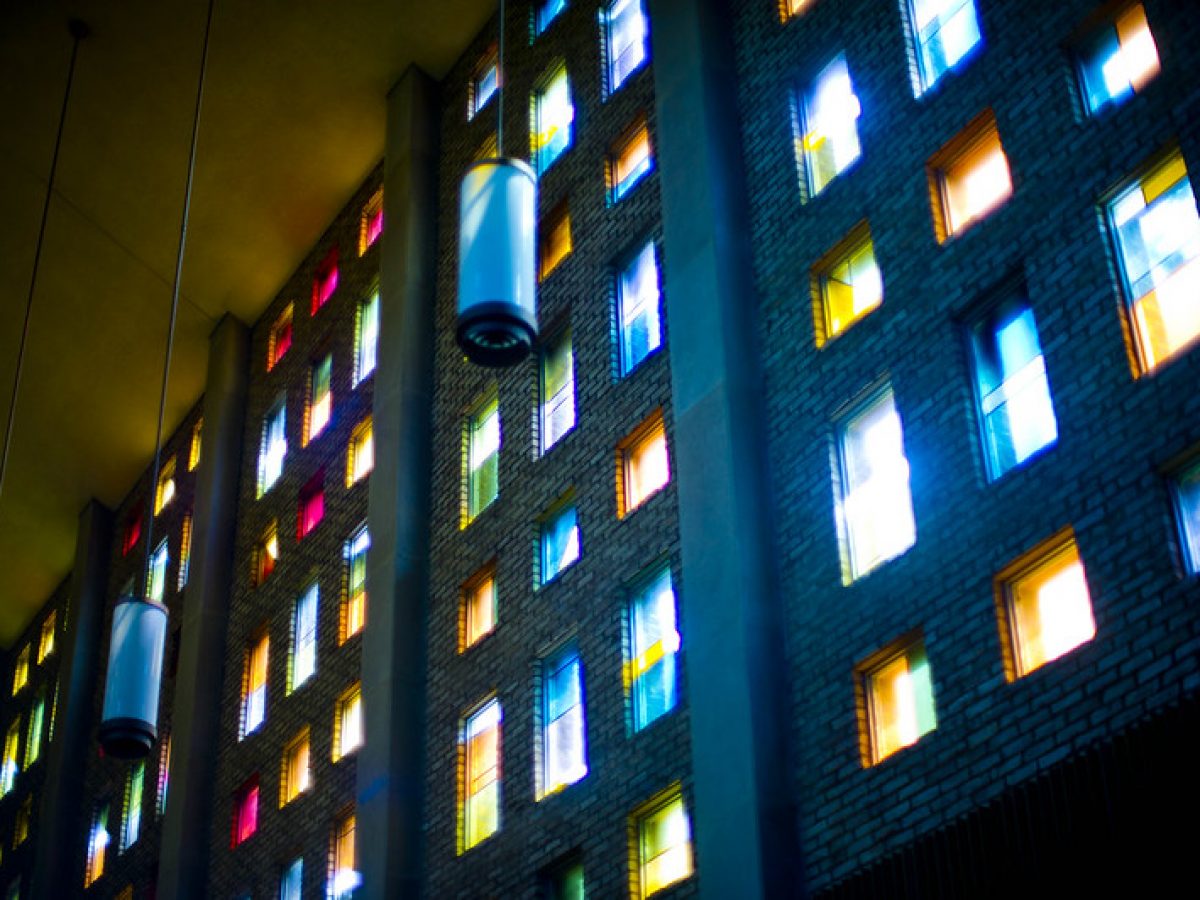 Image inside Benton Chapel shows the light coming through the colorful stained glass windows