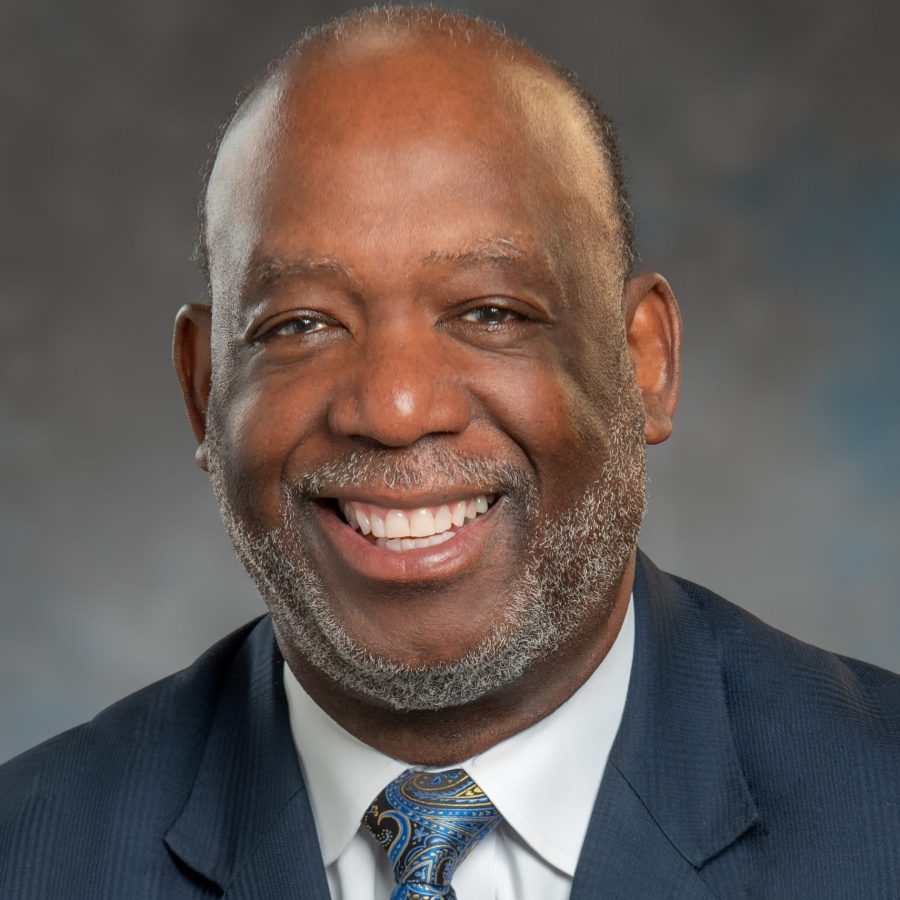 Dr. Forrest Harris wearing a suit and tie